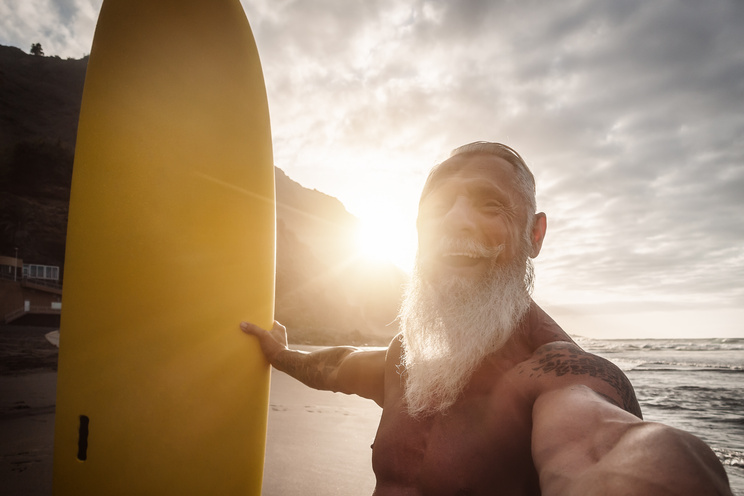 Happy Elderly Man Having Fun During Surfing